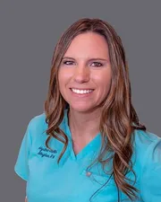 Meghan, registered nurse and founder of Hydra Thrive, smiling in teal Hydra Thrive scrubs